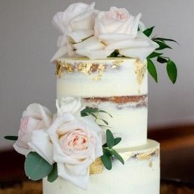 A naked celebration cake topped with roses